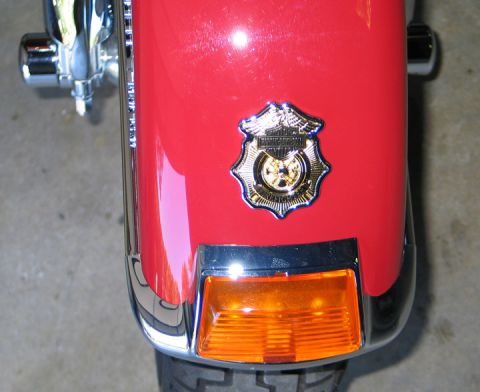 1994 Ford Bronco - A close-up of a motorcycle fender shows a decorative badge and amber turn signal.