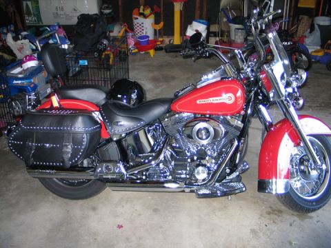 1994 Ford Bronco - Red Harley-Davidson motorcycle parked indoors with saddlebags and a windshield.