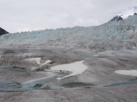 1973 Ford Ranchero - A vast glacier landscape under a cloudy sky, showing intricate patterns of ice and meltwater.