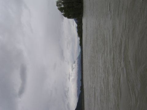 1973 Ford Ranchero - A wide river flows through a landscape with distant mountains and a cloudy sky.