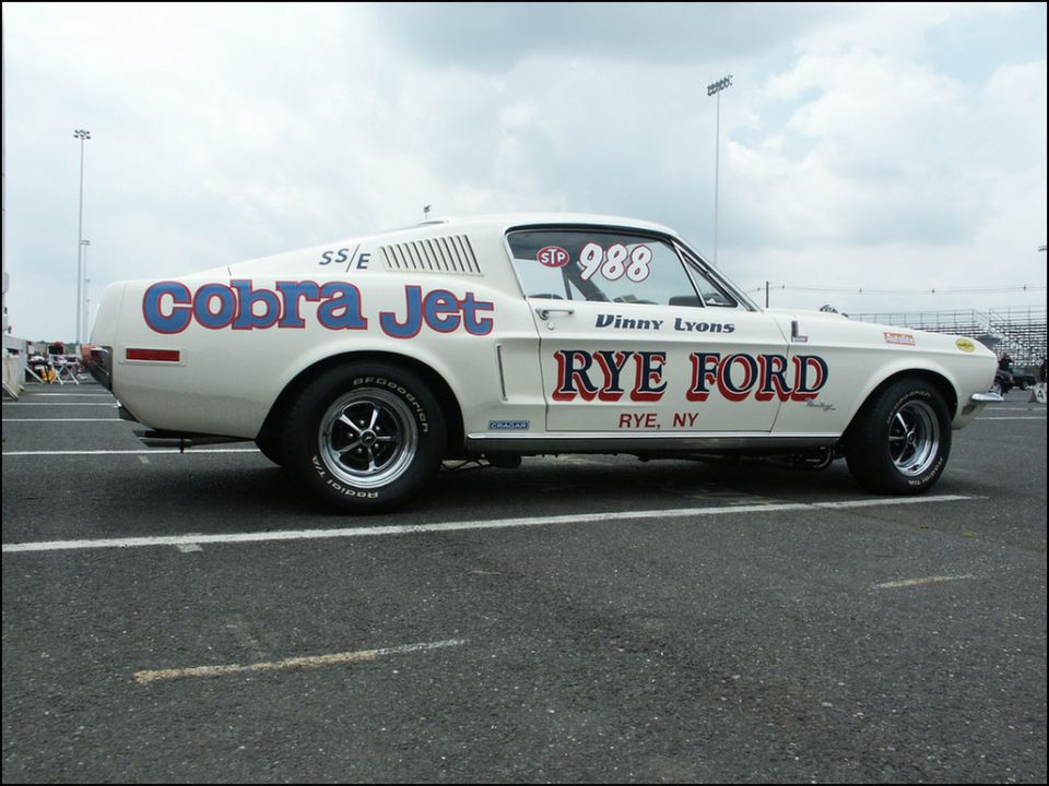 White 1967 Ford Mustang Cobra Jet race car with blue lettering, number 988, and "Rye Ford" livery