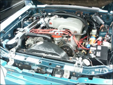 2001 Mercury Grand Marquis - The engine bay of a vehicle is shown with the hood open, revealing the motor and associated components.