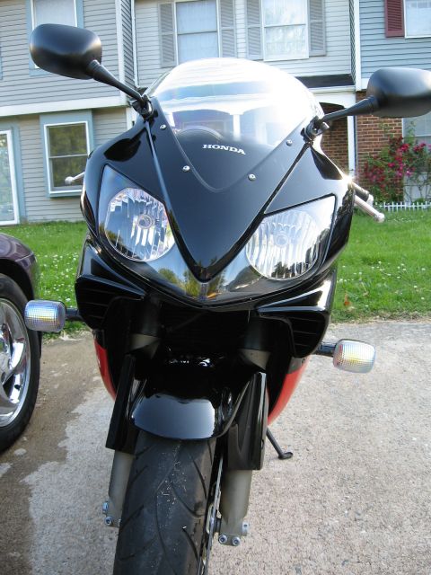 2004 Honda CBR600F - Front view of a 2004 Honda CBR600F motorcycle with black fairing and dual headlights.
