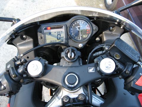 2004 Honda CBR600F - Close-up of a motorcycle's instrument cluster, including a digital speedometer and analog tachometer.