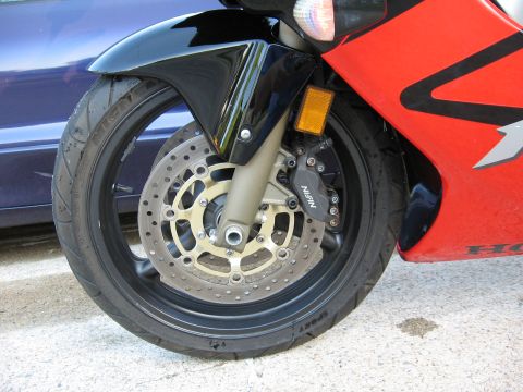 2004 Honda CBR600F - Front wheel and fairing detail of a 2004 Honda CBR600F motorcycle.