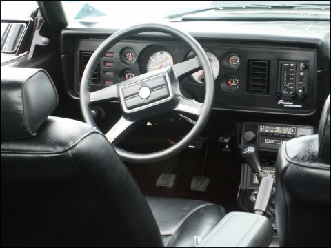 2001 Mercury Grand Marquis - Dashboard and steering wheel of a car interior, showing gauges and radio controls.