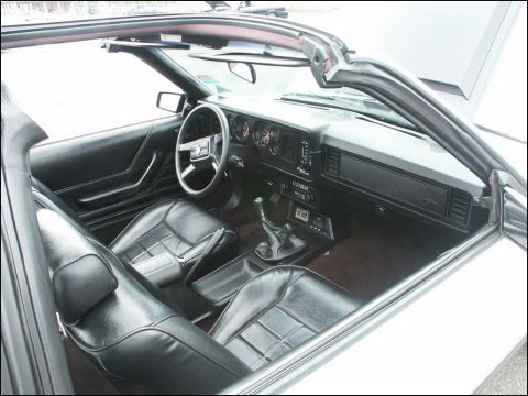 2001 Mercury Grand Marquis - The interior of a convertible shows black leather seats and a manual transmission shifter.