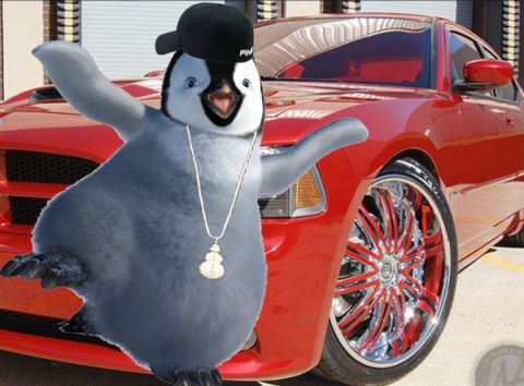 1997 Ford Crown Victoria - A cartoon penguin poses with a red car that has flashy chrome and red rims.