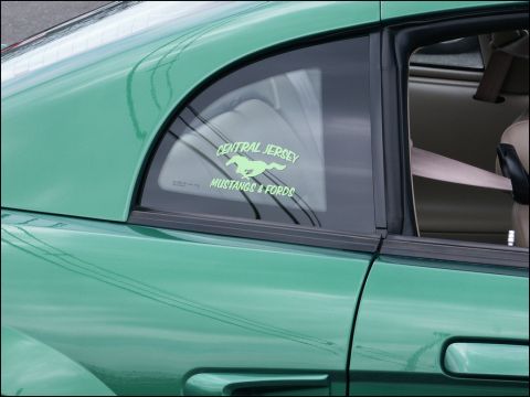 2001 Mercury Grand Marquis - A green car's rear quarter window displays a decal for 'Central Jersey Mustangs & Fords'.