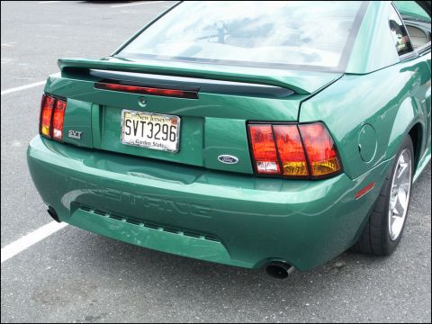2001 Mercury Grand Marquis - Rear view of a green 2001 Ford Mustang SVT, showing its distinctive taillights and spoiler.