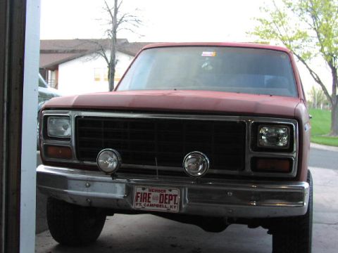 1981 Ford Bronco - This red Ford Bronco features a "Fire Dept" license plate and auxiliary lights on the front grille.