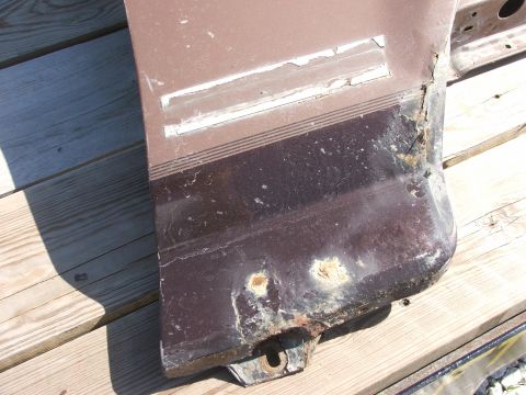 1994 Ford Bronco - This brown fender shows significant rust and peeling paint, with a decorative stripe detail.