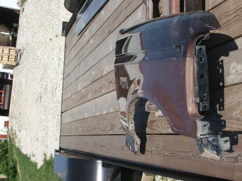 1994 Ford Bronco - A detached vehicle fender is shown on a wooden trailer, likely for sale or transport.