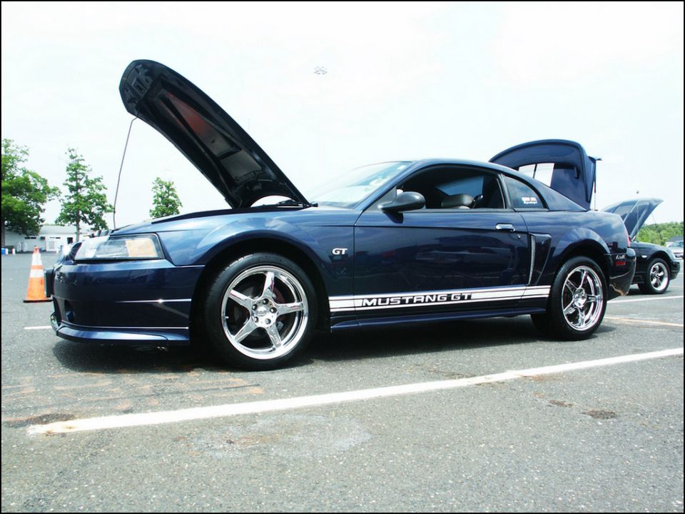 Blue 2001 Ford Mustang GT with hood and trunk open, side view