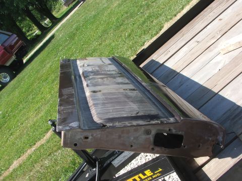 1994 Ford Bronco - A detached car door is shown on a trailer, with a red truck in the background.