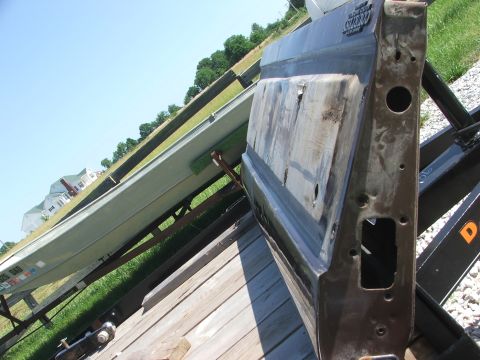 1994 Ford Bronco - Car door on trailer, with a boat also on a trailer in the background.
