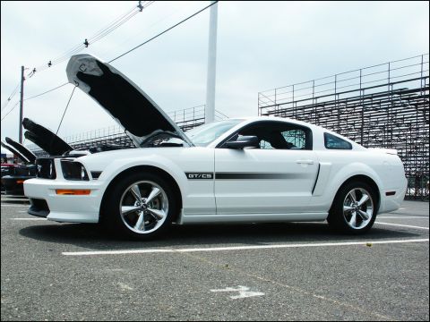 2001 Mercury Grand Marquis - A white Ford Mustang GT/CS is parked with its hoods open, revealing the engine bay. The car is a 2005 model.