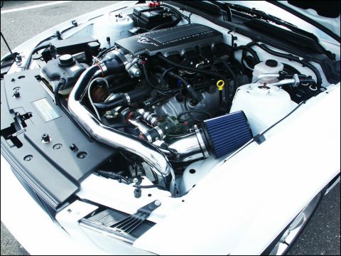 2001 Mercury Grand Marquis - Engine bay of a white car features an aftermarket cold air intake system and polished piping.