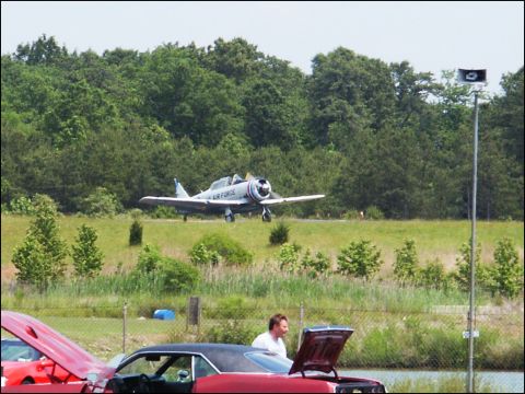 2001 Mercury Grand Marquis - An Air Force training aircraft is seen in the background while people examine cars at an outdoor event.