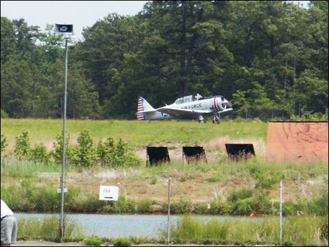 2001 Mercury Grand Marquis - An Air Force airplane sits on a grassy field with trees in the background.