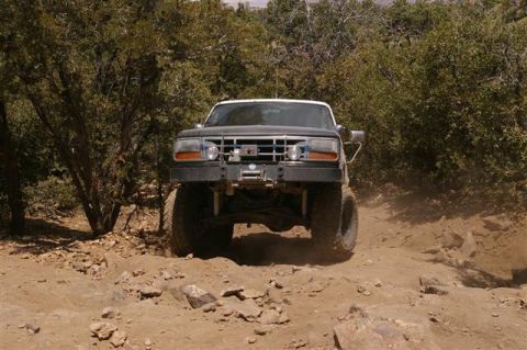 1986 Ford Bronco - This modified 1992 Ford Bronco is navigating a challenging off-road path.