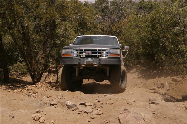 Modified 1992 Ford Bronco climbing a rocky trail