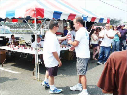 2001 Mercury Grand Marquis - Attendees receive trophies at an outdoor car and truck show event.