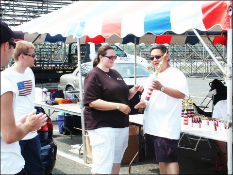 2001 Mercury Grand Marquis - People gathered at an outdoor event, possibly a car show, with trophies displayed.