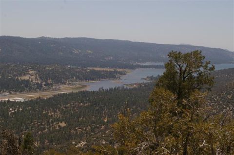 1986 Ford Bronco - A wide view of a lake and forested hills, with an airport in the valley below.