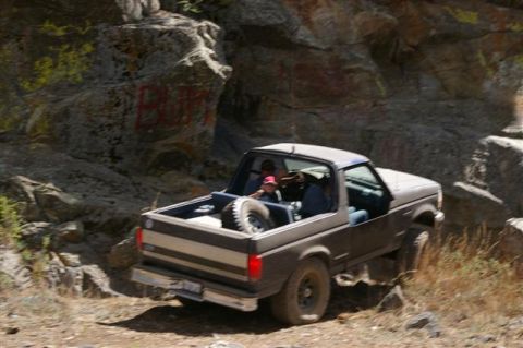 1986 Ford Bronco - Ford Bronco navigates a rough, rocky terrain on an off-road adventure.