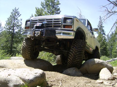 1986 Ford Bronco - This modified 1980 Ford Bronco navigates a rocky trail with its front tires high off the ground.