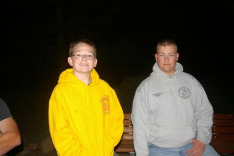 1986 Ford Bronco - Two young individuals pose for a photo outdoors at night, with one wearing a bright yellow hoodie.