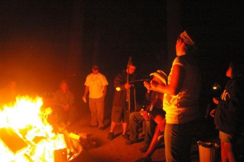 1986 Ford Bronco - A group of people enjoy a warm campfire on a dark night.
