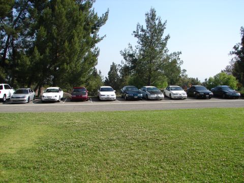 1992 Ford Taurus - Several sedans are parked in a lot, with a 1992 Ford Taurus among them.