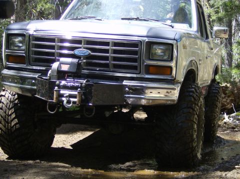 1986 Ford Bronco - This lifted Ford Bronco is equipped with a winch and off-road tires, ready for rough terrain.