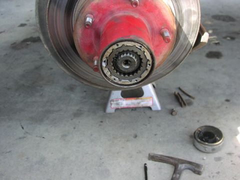 1981 Ford Bronco - This is a close-up of a vehicle's front wheel hub and brake rotor assembly, supported by a jack stand.