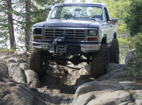 1986 Ford Bronco - Modified Ford Bronco tackling a challenging rocky trail.