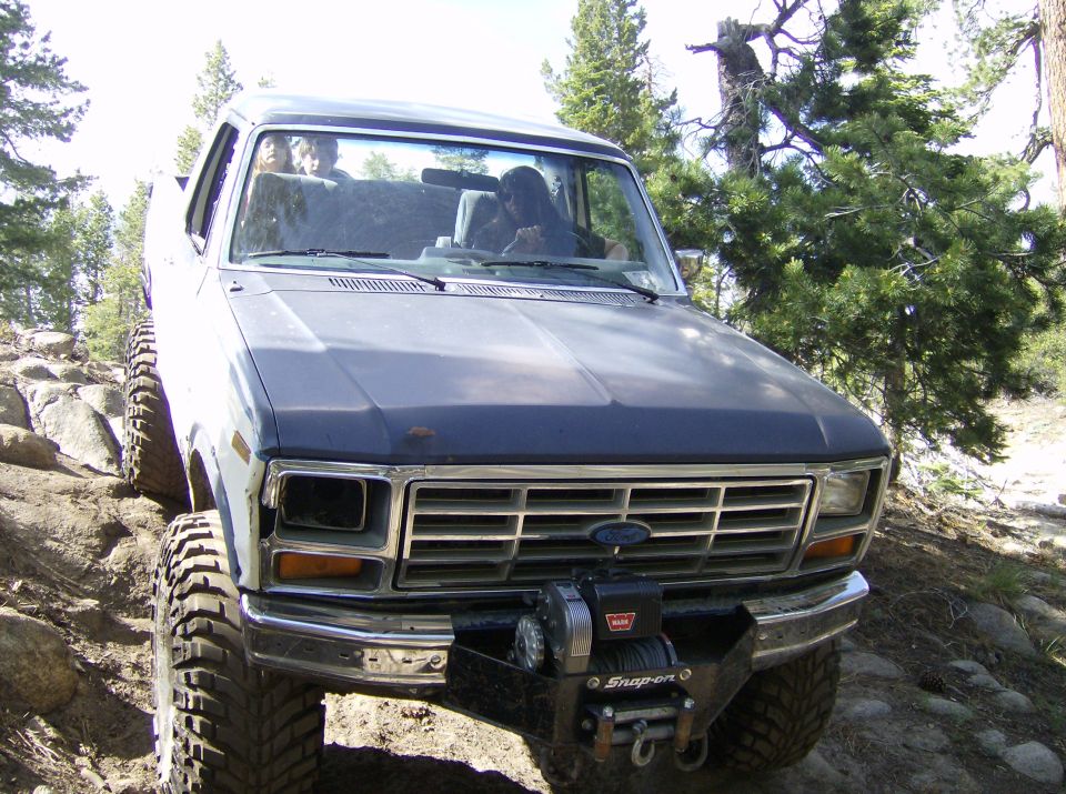 1986 Ford Bronco front view with winch on rocky terrain