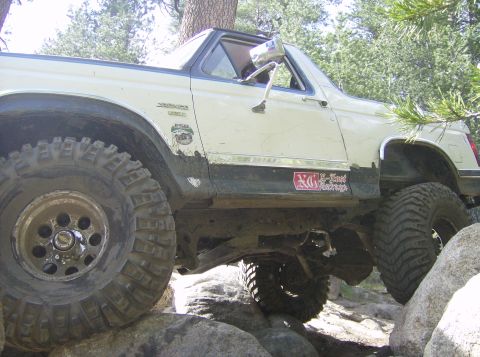 1986 Ford Bronco - This 1986 Ford Bronco is navigating a rocky trail with its tires elevated.