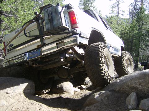 1986 Ford Bronco - This 1986 Ford Bronco is shown navigating a rocky trail with its rear end visible.