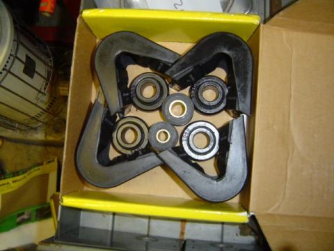1979 Ford Bronco - A box contains suspension bushings and bearings, likely for vehicle repair or maintenance.