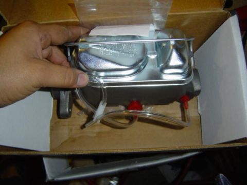 1979 Ford Bronco - A new master cylinder is shown, ready for installation. It appears to be a common aftermarket part.