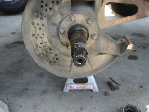 1981 Ford Bronco - Close-up of a vehicle's wheel hub assembly, including the brake rotor and axle splines.