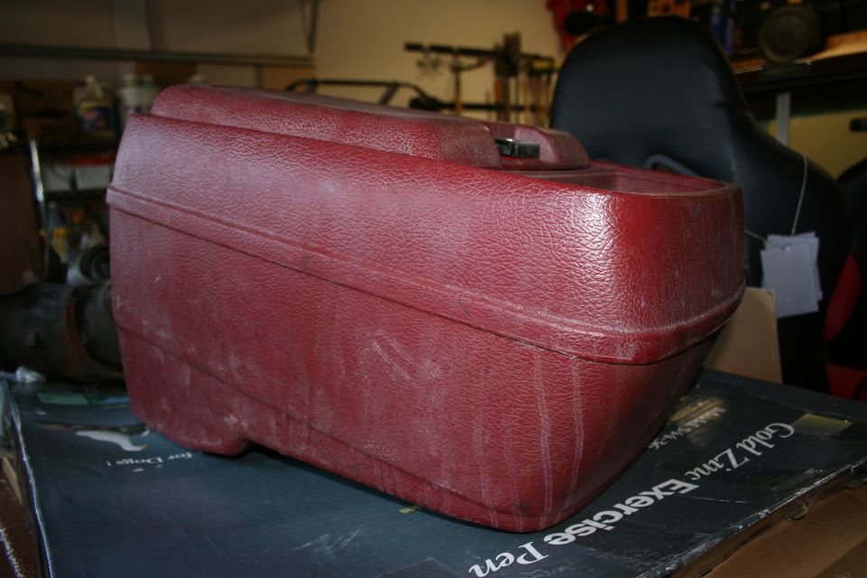 red plastic storage box on top of a book