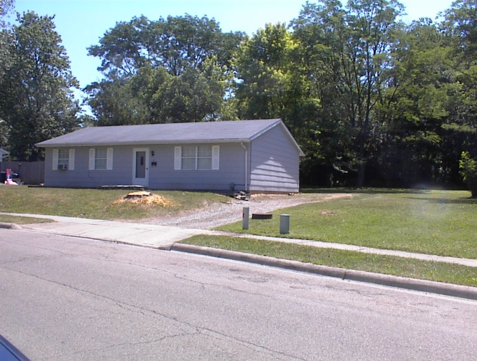 House with a tree stump in the yard