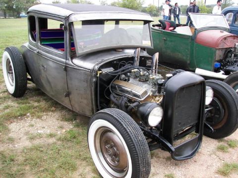1972 Ford Ranchero - A custom hot rod coupe sits parked next to another vintage vehicle.