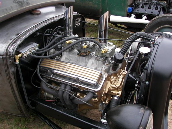 Custom hot rod engine with dual carburetors and gold-finned valve covers