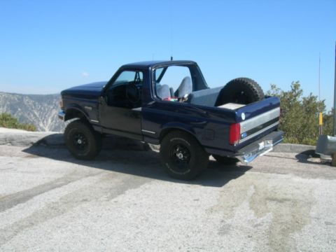 1994 Ford Bronco - This Ford Bronco is parked at a scenic overlook with a spare tire mounted in the bed.