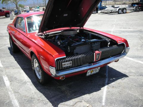1992 Ford Crown Victoria - 1969 Mercury Cougar with its hood open, revealing the engine bay.