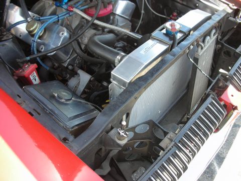 1992 Ford Crown Victoria - Close-up view of a vehicle's engine bay, focusing on the radiator and associated plumbing.